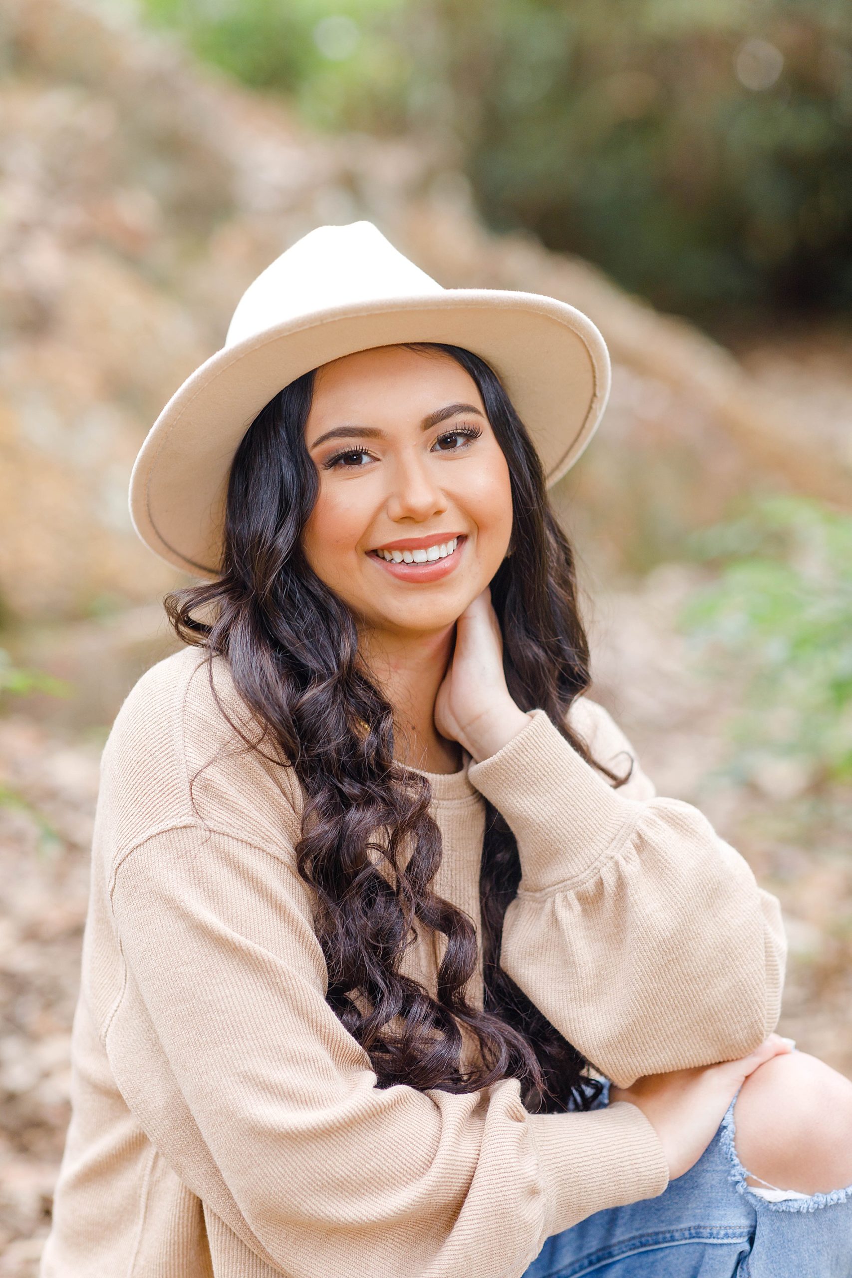 Senior portrait with tan hat and neutral clothing 