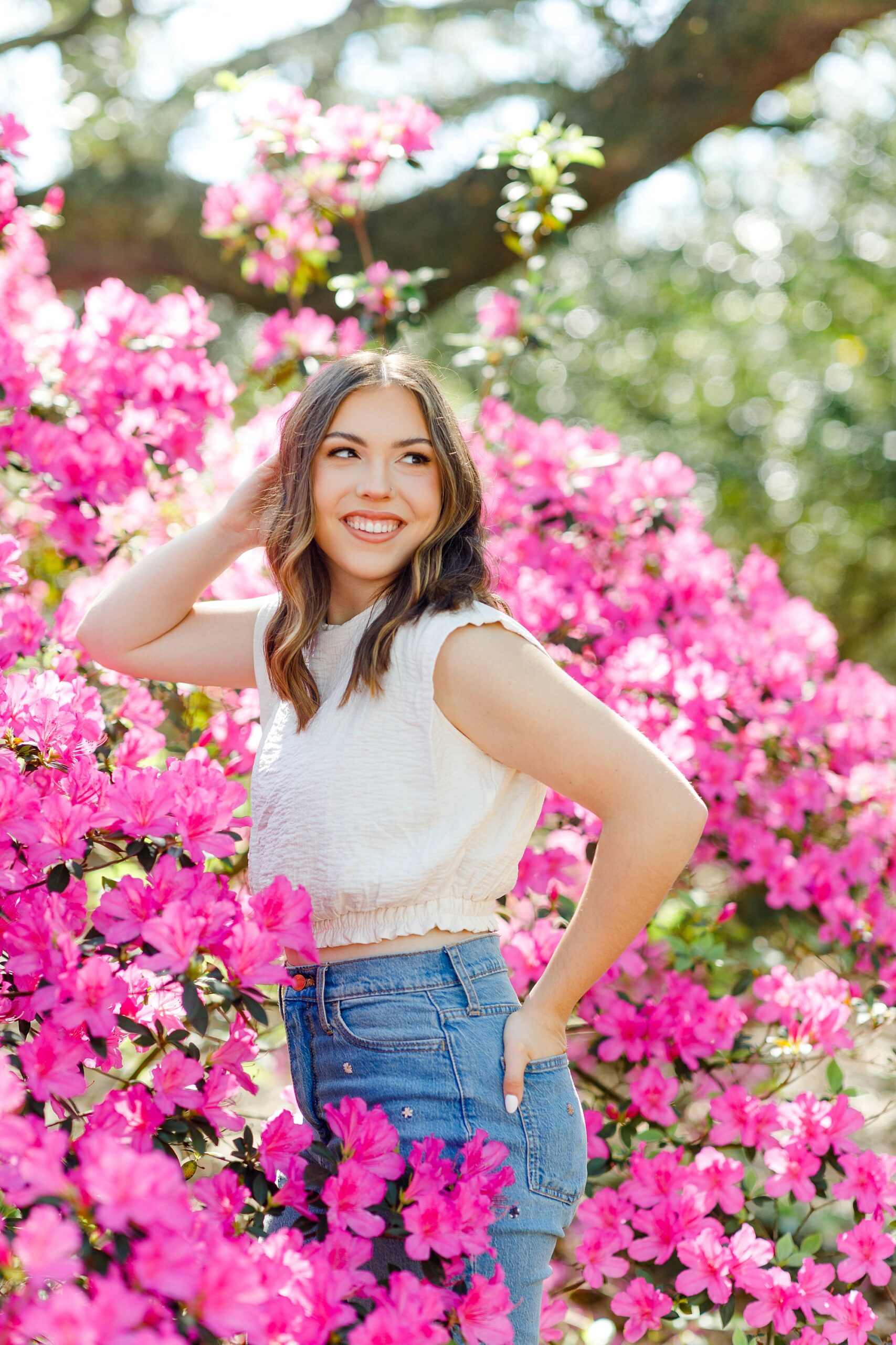 senior portraits by pink flowers 
