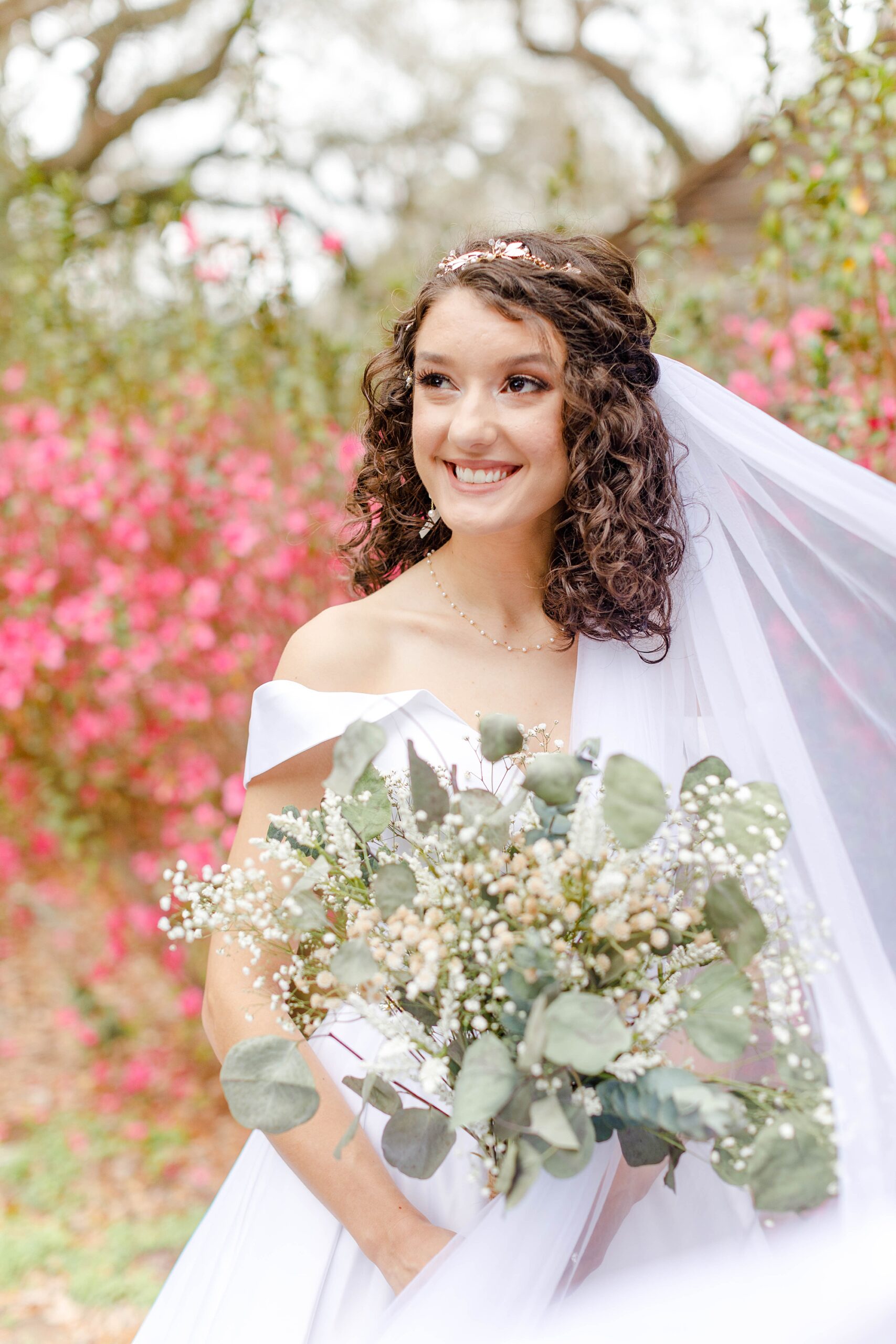 bride holds bouquet of greenery 