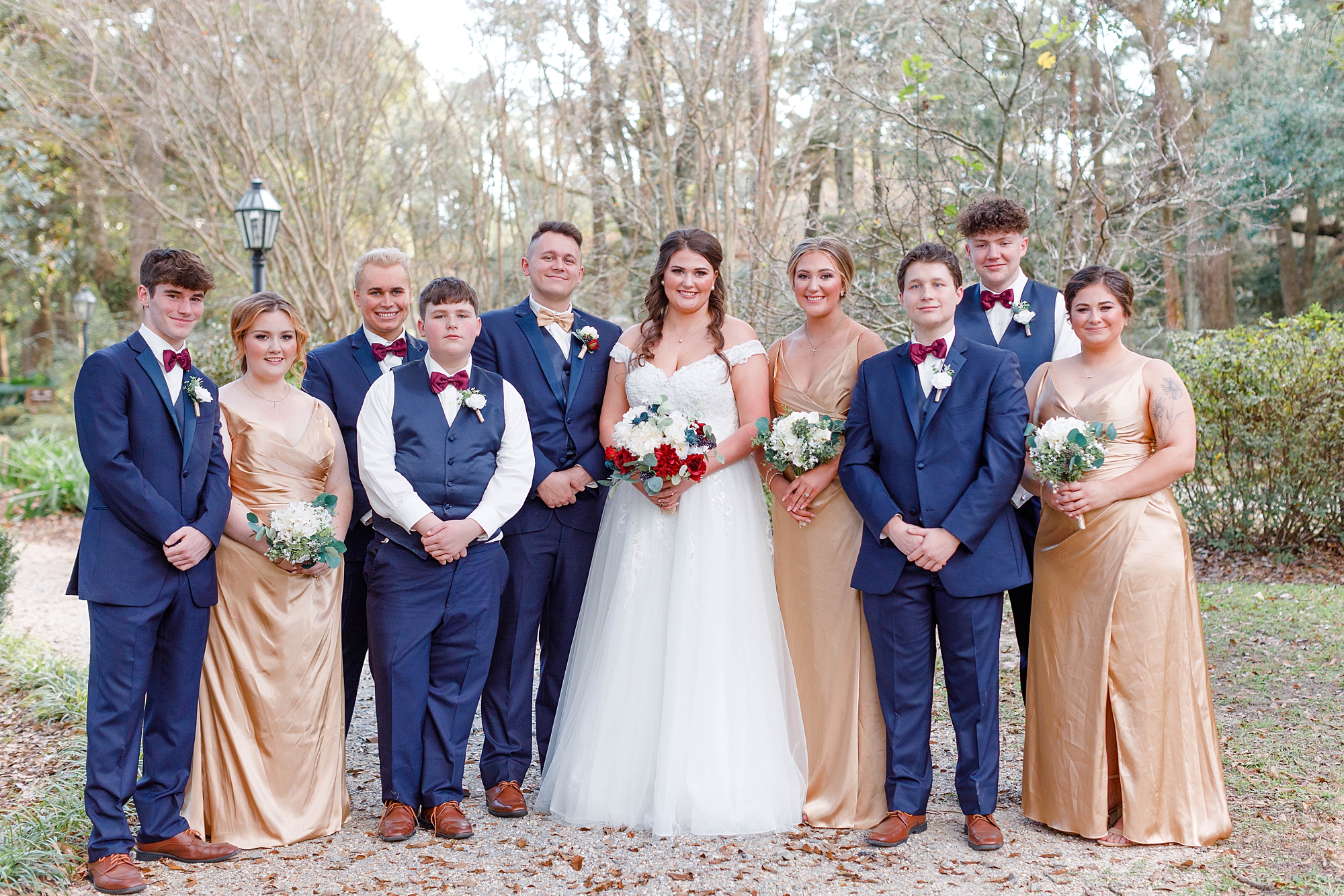 groomsmen in navy suits and bridesmaids in gold dresses 