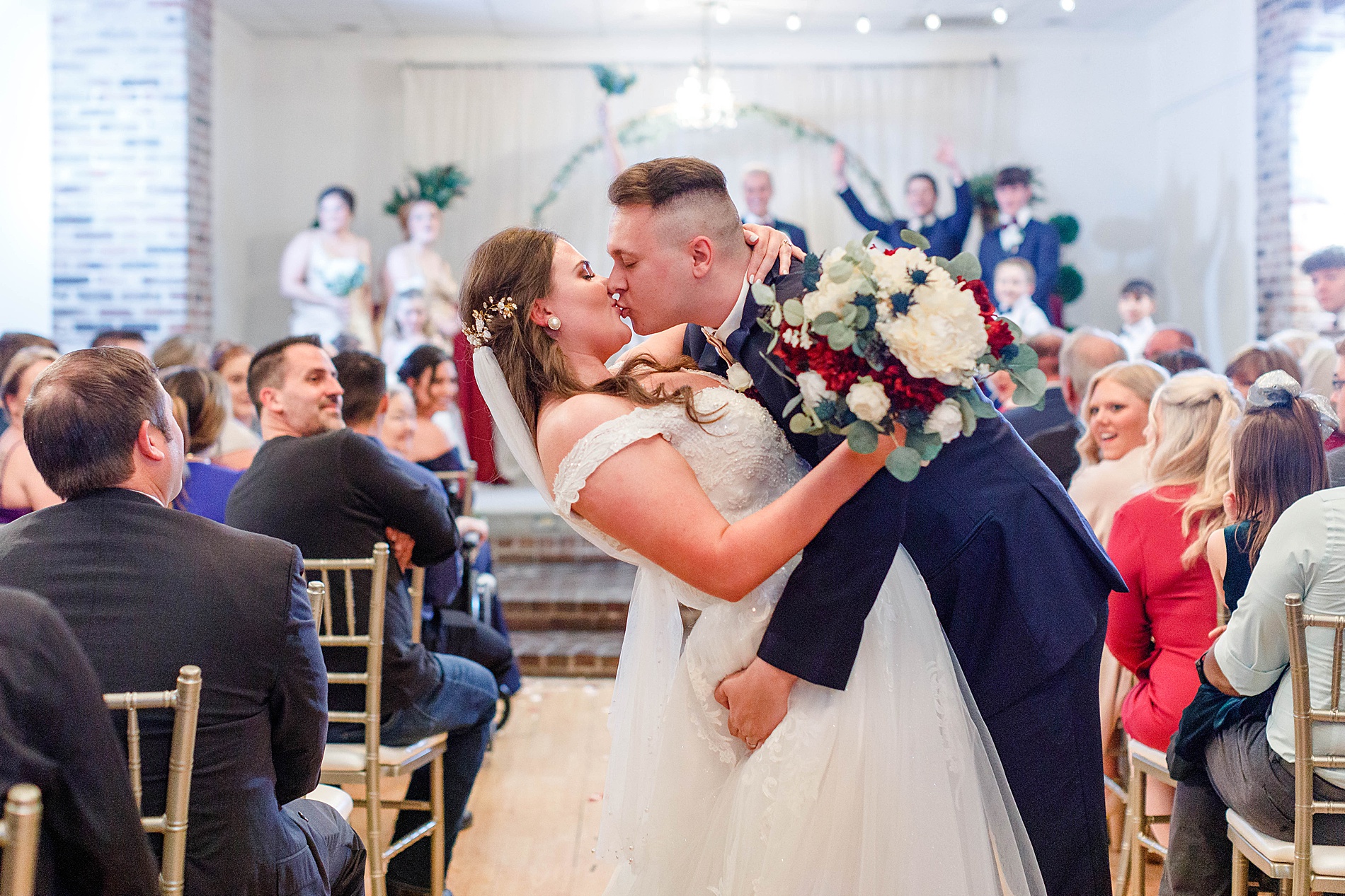 couple kiss after wedding ceremony